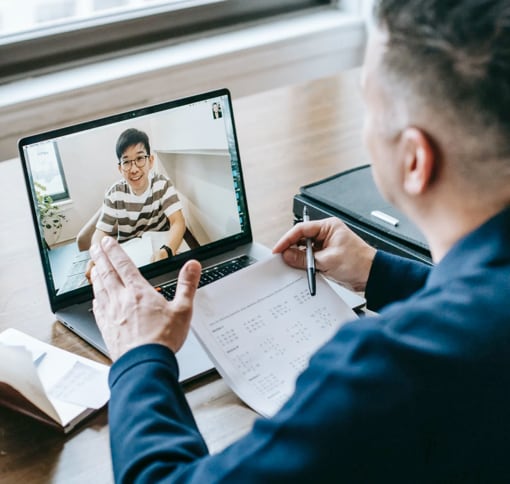 Man using laptop for a video meeting.